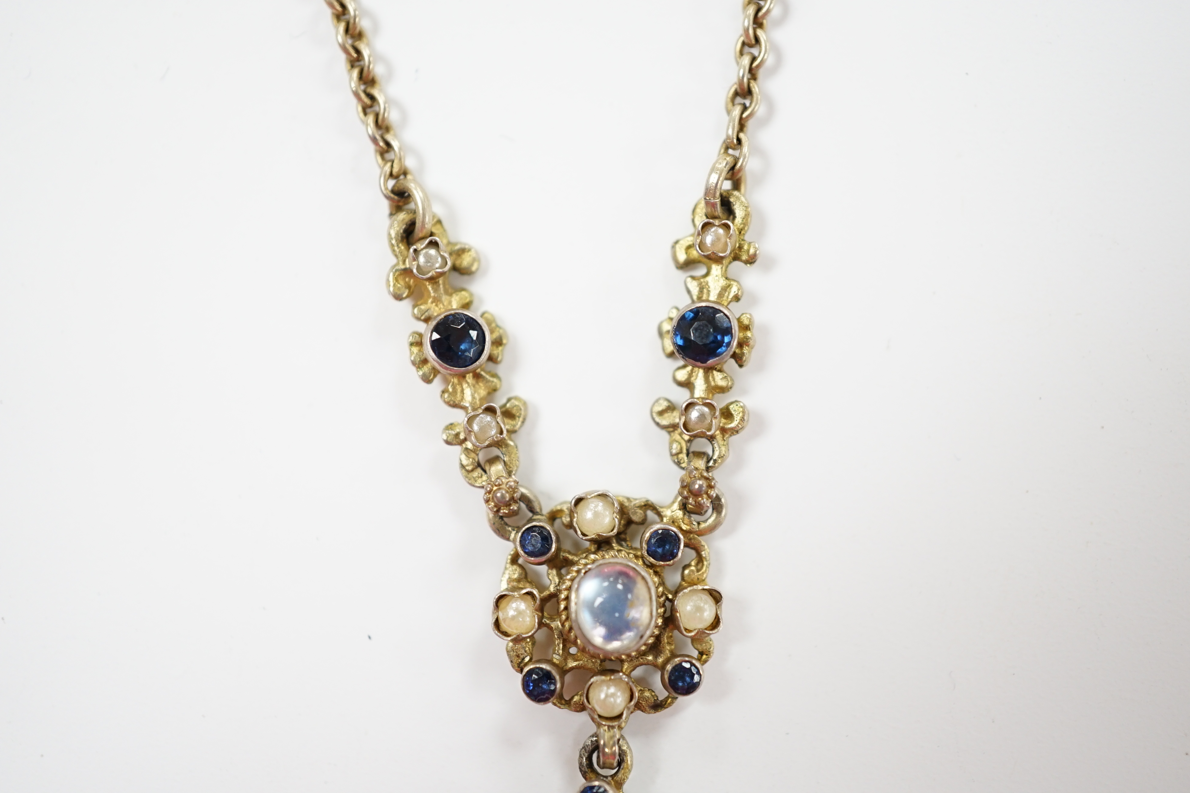 A 19th century Austro Hungarian, gilt white metal, moonstone, split pearl and gem set drop pendant necklace, overall 56cm.